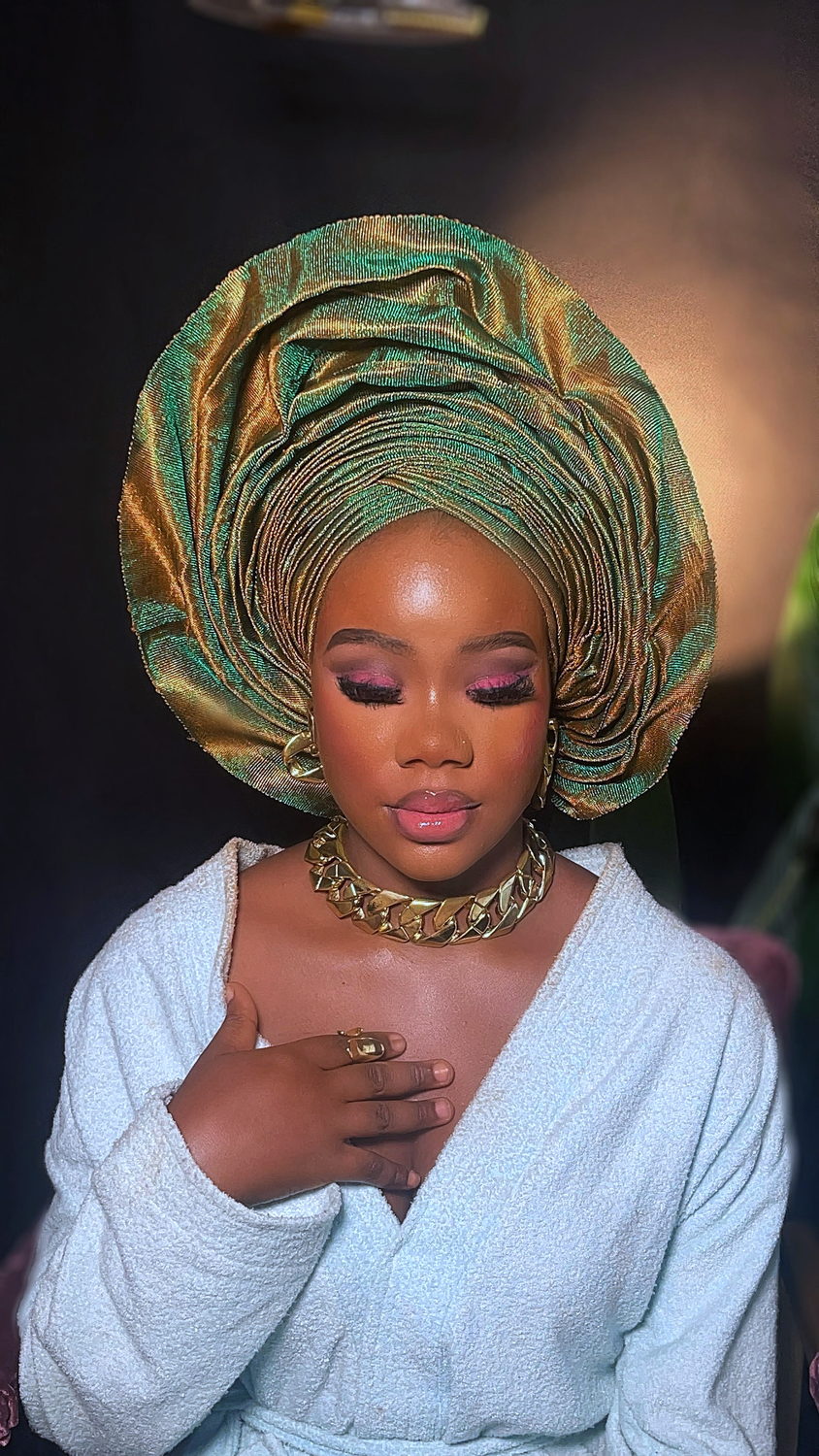 Architectural green and gold metallic gele with soft pink smoky eyes, dewy glass skin and chunky gold jewellery